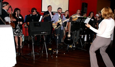band on a full stage and woman planing air guitar