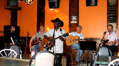 Albert singing and playing guitar, with Coyotes backup