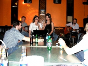 Amalee and Stephanie singing with Eric and Peter playing guitar