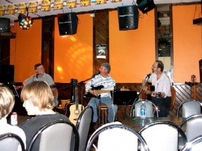 Eric, Burke, Peter playing guitar and smiling