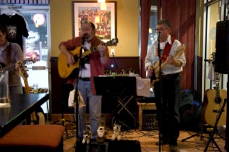 Peter singing and playing guitar, Burke on bass