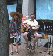 Mexican dressed woman singing,Eric playing backup guitar