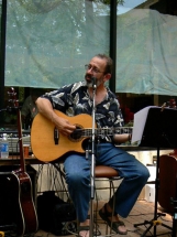 Peter sitting playing guitar