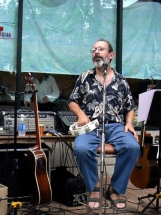 Peter sitting and playing tambourine