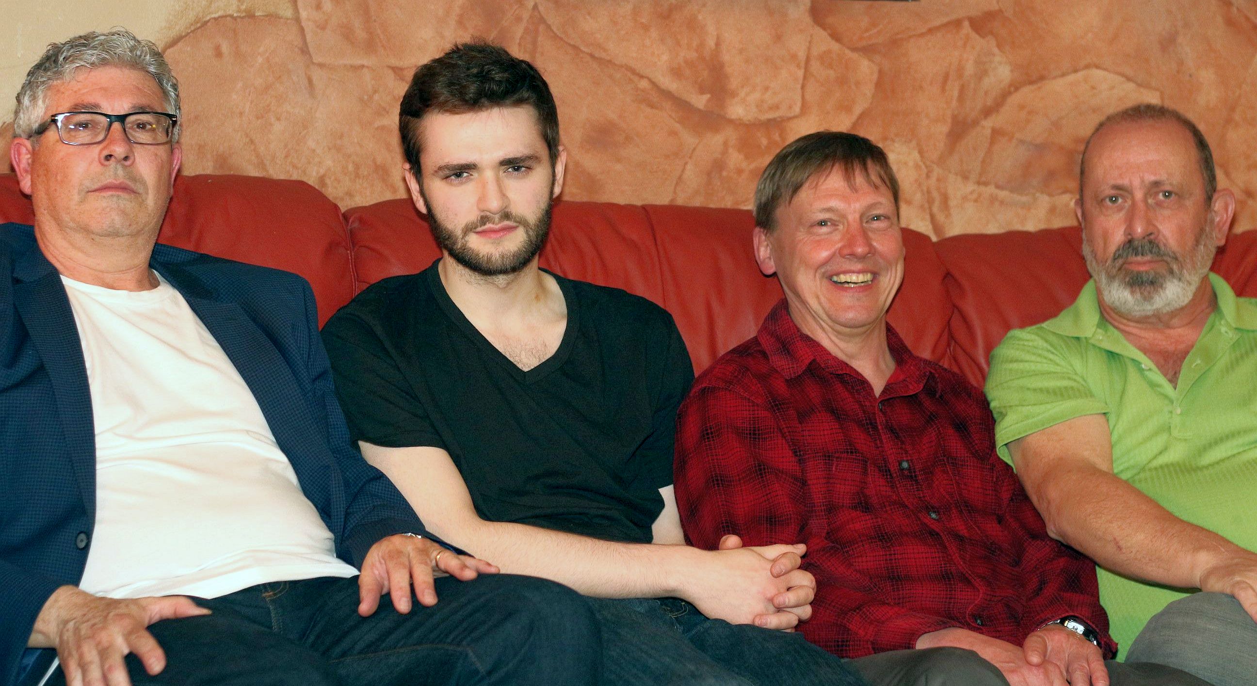 Coyotes on the couch. Everyone grumpy faced except grinning Eric.